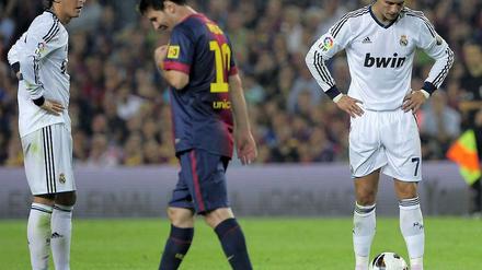 Gesenkte Köpfe: Sowohl Cristiano Ronaldo (r.) als auch Lionel Messi (m.) erzielten zwei Treffer, doch einen Sieg konnten beide nicht einfahren. Mesut Özil (l.) stand bei Real in der Startelf und bereitete den 2:2-Ausgleich vor.