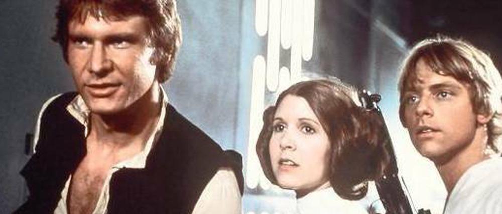 Die Zukunft von gestern. Harrison Ford, Carrie Fisher und Mark Hamill spielten 1977 die Hauptrollen in „Krieg der Sterne“. Fünf weitere „Star-Wars“-Filme folgten, wobei der erste Teil heute auf Grund seines Platzes in der Chronologie „Episode IV“ heißt. 
