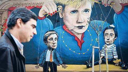 Ist Angela Merkel diejenige, nach deren Pfeife alle tanzen? Die portugiesische Protestbewegung zumindest hält ihre eigene Regierung für willfährige Marionetten.