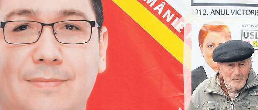 Vor einem Wahlplakat des sozialistischen Premiers Viktor Ponta verkauft ein Mann in Bukarest Knoblauch. 