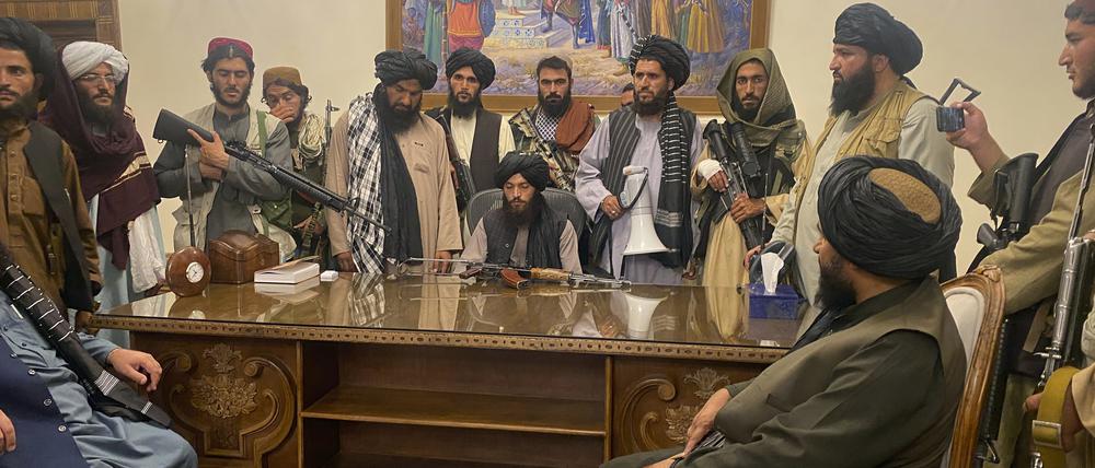 Taliban-Kämpfer sitzen in einem Raum des Präsidentenpalastes. 