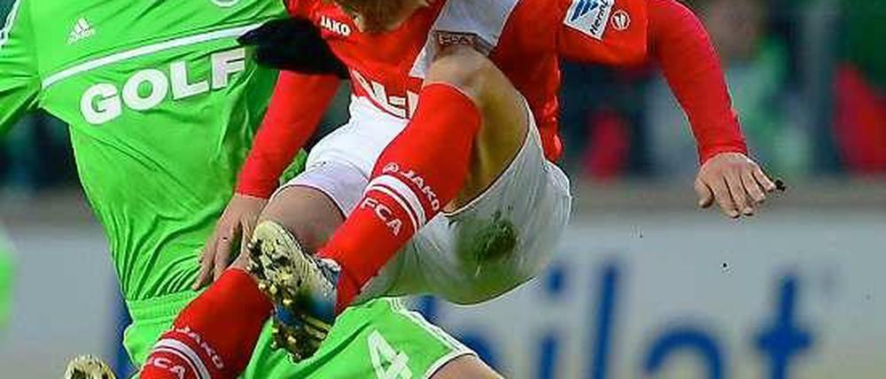 Augsburger Zweikampfführung: Der früherer Wolfsburger Ja-Cheol Koo (r.) wirft sich in einen Zweikampf mit Marcel Schäfer.