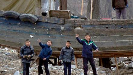 Nordkoreanische Kinder werfen Steine in den Yalu-Fluss an der nordkoreanisch-chinesischen Grenze bei Sinuiju und Dandong.