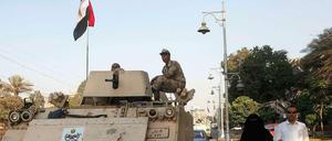 Ein Paar in Kairo läuft neben einem Panzer der ägyptischen Armee.