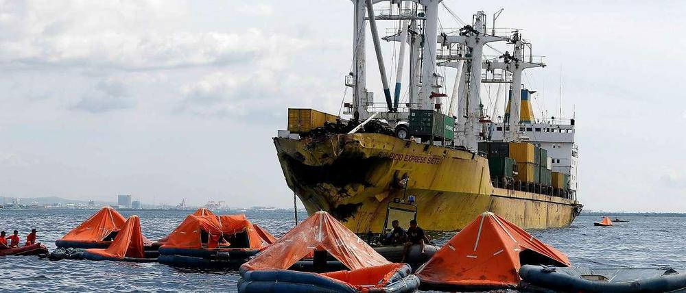 Helfer suchen im Wasser nach vermissten Passagieren.