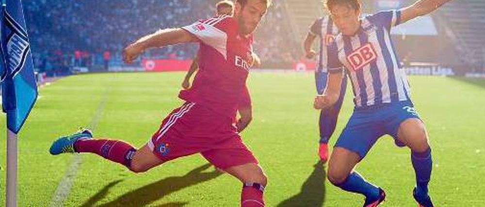 Der Sonne entgegen. Hamburgs Rafael van der Vaart (r.) im Zweikampf mit Herthas Nico Schulz. Foto: dpa