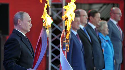 Alles unter Kontrolle. Russlands Präsident Wladimir Putin mit Feuer, mit dem die Olympischen Winterspiele 2014 in Sotschi eröffnet werden sollen. 