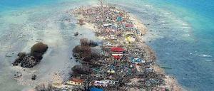 Küste ohne Schutz. Dieses Foto einer vom Taifun verwüsteten Insel in der zentralphilippinischen Provinz Samar zeigt beispielhaft den fehlenden Schutz. Die Mangrovenwälder sind verschwunden, die hellen Flecken im Meer zeigen, dass viele Sedimente in die Seegraswiesen geschwemmt worden sind, und selbst die Korallenriffe etwas weiter draußen sind teilweise mit Sand bedeckt. 