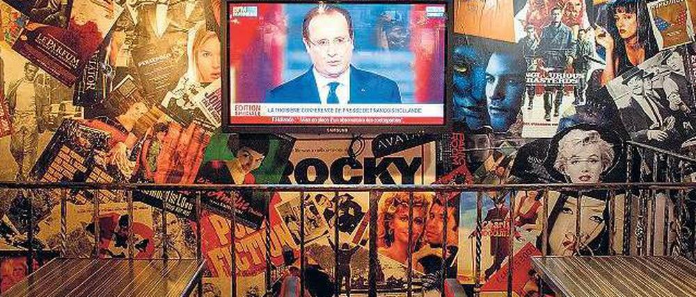 Botschaft für die Öffentlichkeit. In einer Bar in Paris läuft die Fernsehübertragung mit den wirtschaftlichen Plänen des Staatschefs François Hollande.