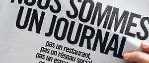 „Wir sind eine Zeitung“, mit dieser Schlagzeile protestiert die Redaktion der „Libération“ gegen die Umbaupläne. Foto: AFP