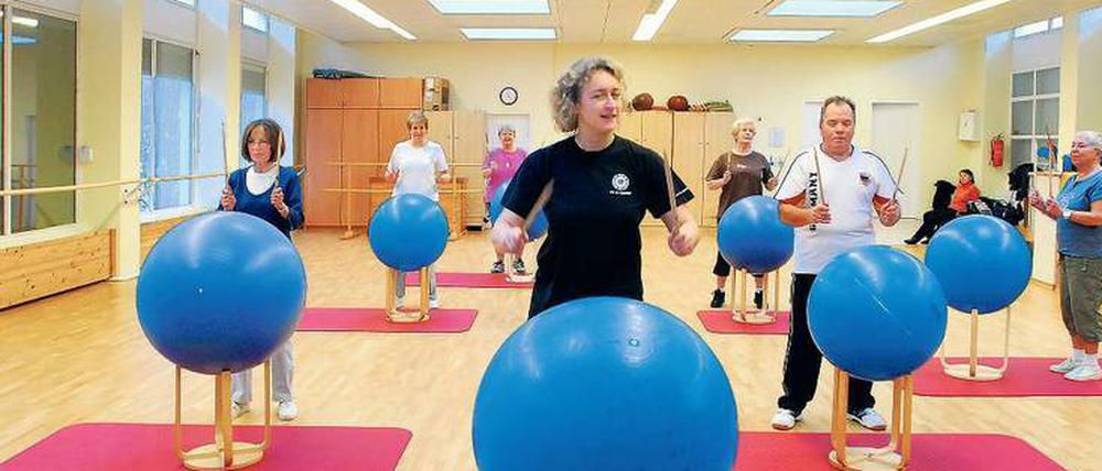 Trommeln für die Fitness. Diese Teilnehmer eines Senioren-Gymnastik-Kurses im Märkischen Viertel in Berlin tun etwas für ihre Gesundheit.