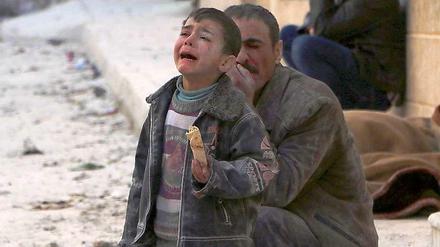 A boy cries at a site hit by what activists say was an airstrike by forces loyal to Syrian President Assad in Masaken Hanano in Aleppo February 14, 2014.