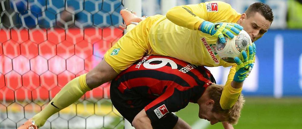 Krumm gebuckelt. Raphael Wolf sichert den Ball vor Frankfurts Stefan Aigner.