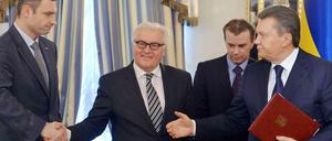 Der deutsche Außenminister Frank-Walter Steinmeier (mitte) Ende Februar 2014 in der Ukraine mit den politischen Gegnern Vitali Klitschko (l.) und Viktor Janukowitsch.