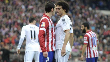 Auge um Auge. Atlético und Real (hier Diego Godin und Pepe) sind in diesem Jahr in Spanien und in Europa Titelaspiranten.