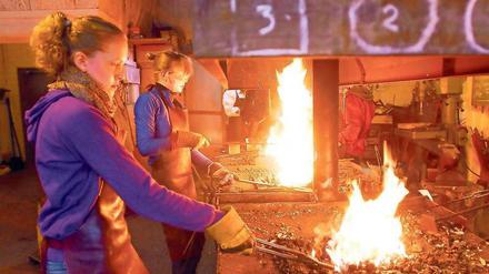 Zwei Eisen im Feuer. Die praktische Vorbereitung aufs (Berufs-)Leben ist wichtiger Bestandteil der Waldorfpädagogik. Hier lernen Schülerinnen der Rudolf Steiner Schule in Berlin-Dahlem das Schmiedehandwerk. 