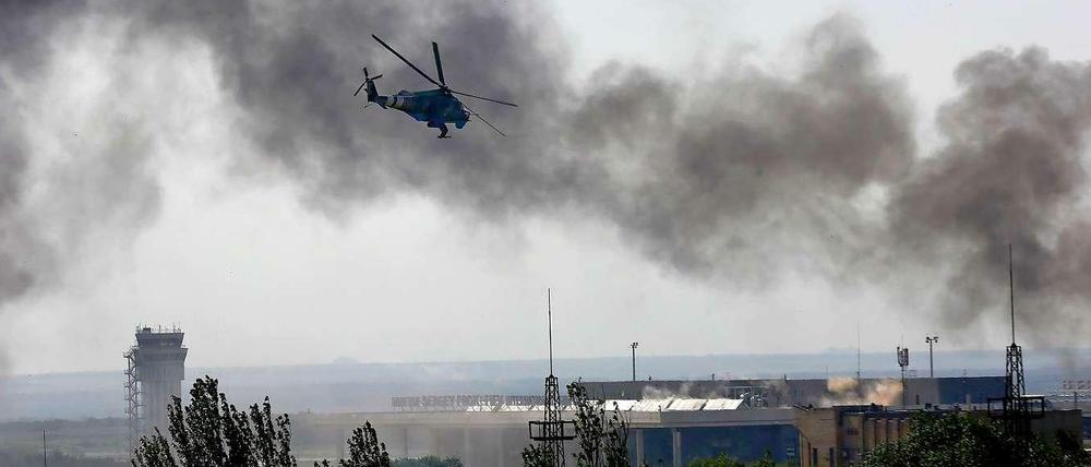 Ein ukrainischer Helikopter schießt auf pro-russische Separatisten auf dem Hauptgebäude des Internationalen Flughafens Donetzk.