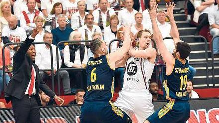 Hände hoch! Die Alba-Spieler Sven Schultze und Vojdan Stojanovski umzingeln Quakenbrücks Chad Topper, auch Quakenbrücks Trainer Tyron McCoy (links) streckt sich.