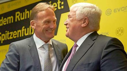BVB holt sich Millionen. Der Geschäftsführer des Fußball-Bundesligisten Borussia Dortmund, Hans-Joachim Watzke (l), und der Vorstandsvorsitzende des Spezialchemie-Unternehmens Evonik, Klaus Engel, geben sich in Dortmund nach einer gemeinsamen Pressekonferenz im Signal Iduna Park die Hand.