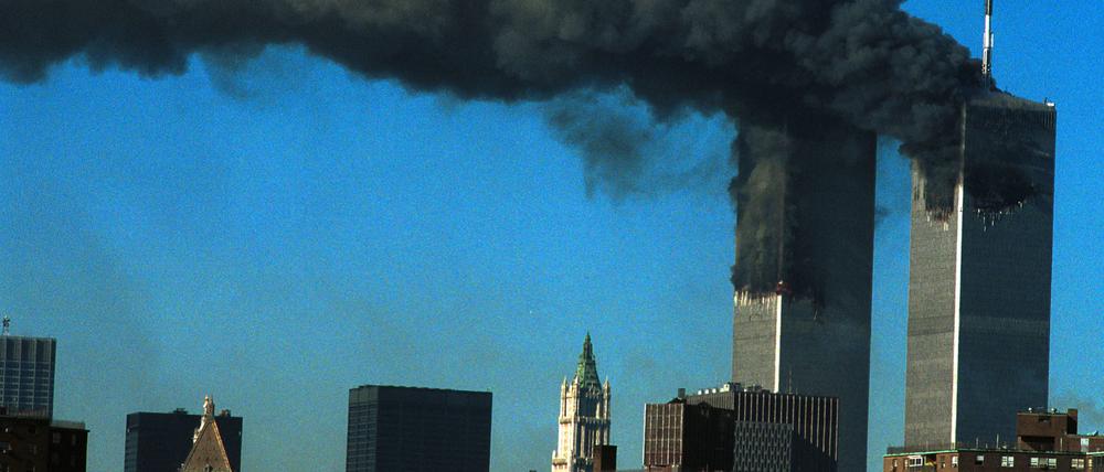 394261 07: Smoke pours from the World Trade Center after being hit by two planes September 11, 2001 in New York City. (Photo by Carolyn Schaefer/Getty Images)