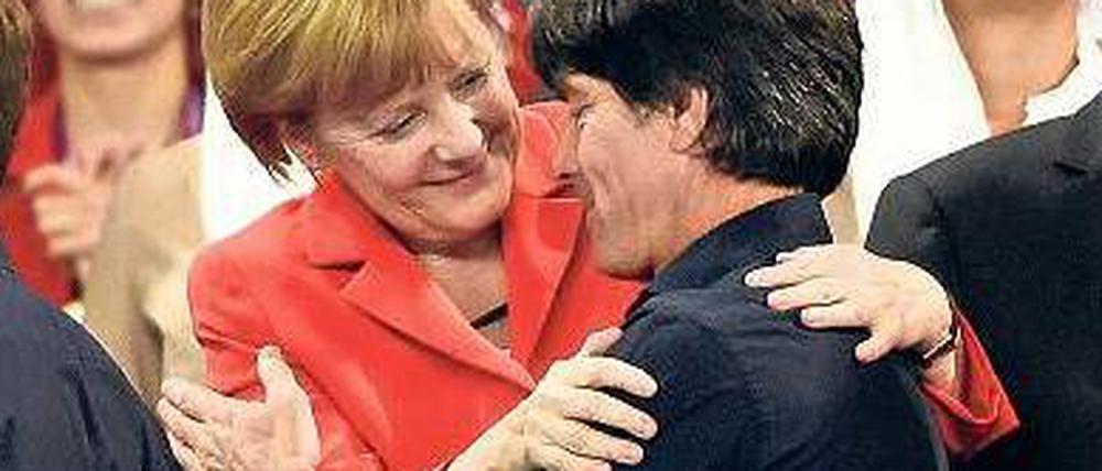 Herzig. Bundeskanzlerin und -trainer engagieren sich auch nach der WM sozial.