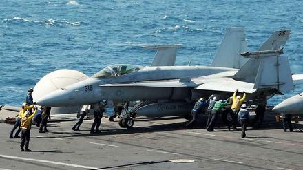 Das Bild der US-Navy zeigt eine F/A-18C Hornet, die auf einem Flugzeugträger für einen Luftangriff auf IS-Terroristen im Irak vorbereitet wird.