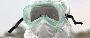 Ganzkörperschutz. Ein Mitarbeiter der Gesundheitsbehörden von Liberia beim Einsatz zur Bergung von toten Ebolaopfern. 