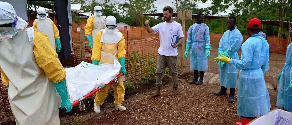 Kailahun liegt inmitten der am stärksten von Ebola betroffenen Region in Sierra Leone. Das Foto zeigt zwei Mitarbeiter von Ärzte ohne Grenzen, die einen verstorbenen auf einer Trage aus einem Behandlungszelt tragen.