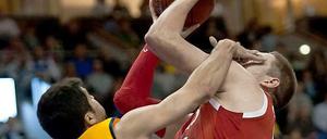 Vojdan Stojanovski (l) von Alba Berlin drückt Vladimir Stimac vom Bayern München die Finger ins Gesicht.