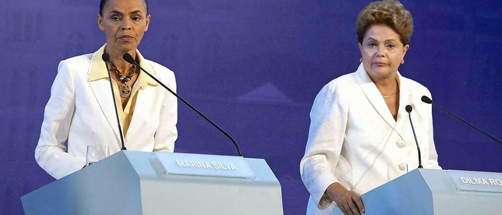Die einen wollen viele Brasilianer loswerden (Dilma Rousseff, r.), die andere wollen viele aber nicht haben (Marina Silva, l.).