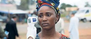 Strenge Grenzkontrolle. Einer Frau aus Guinea wird an der Grenze zu Mali die Körpertemperatur gemessen. 