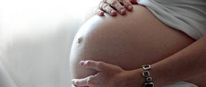 ARCHIV - 25.03.2012, Brandenburg, Hamburg: ILLUSTRATION - Eine Frau hält ihren schwangeren Bauch. (zu dpa "Alkohol in der Schwangerschaft: Thema wird immer noch unterschätzt") Foto: Mascha Brichta/dpa-tmn/dpa +++ dpa-Bildfunk +++