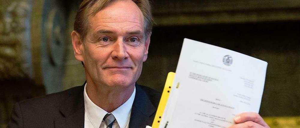 Oberbürgermeister Burkhard Jung (SPD) hält die Anschrift des Urteils des Londoner High Court of Justice hoch.