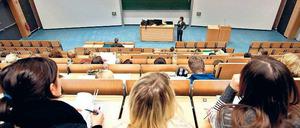 Eine Dozentin steht im Hörsaal vor Studierenden.