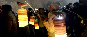 Teilnehmer der islamkritischen Pegida-Bewegung halten Laternen in den Farben schwarz-rot-gold bei einer Kundgebung in Dresden (Sachsen). Für den 26. Januar ist in Brandenburg/Havel eine Pegida-Demonstration angemeldet.