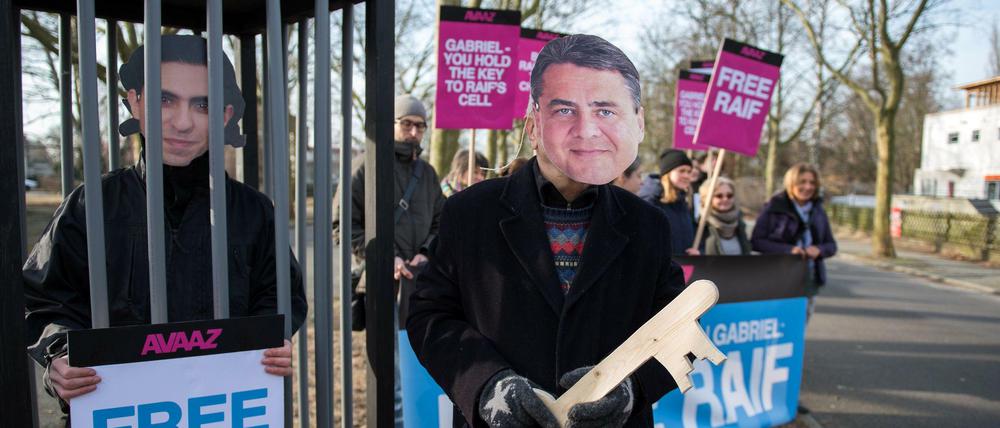 Aktivisten des Bürgernetzwerkes Avaaz stehen am Samstag an der Zufahrt zum militärischen Teil des Flughafen in Berlin Tegel, um vor der Abreise von Bundeswirtschaftsminister Gabriel (SPD) nach Saudi-Arabien auf einen von mehr als einer Million Menschen unterschriebenen Appell hinzuweisen.