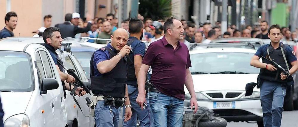 Polizisten riegeln die Gegend ab, nachdem ein Mann von seinem Balkon auf Passanten geschossen hatte. 
