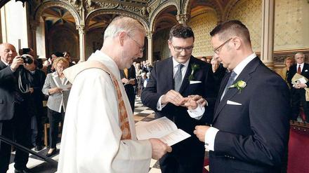 Mit Segen. Der CDU-Bundestagsabgeordnete Stefan Kaufmann (M.) und sein Lebensgefährte Rolf Pfander (r.) in der Alt-Katholischen Gemeinde Stuttgart. 