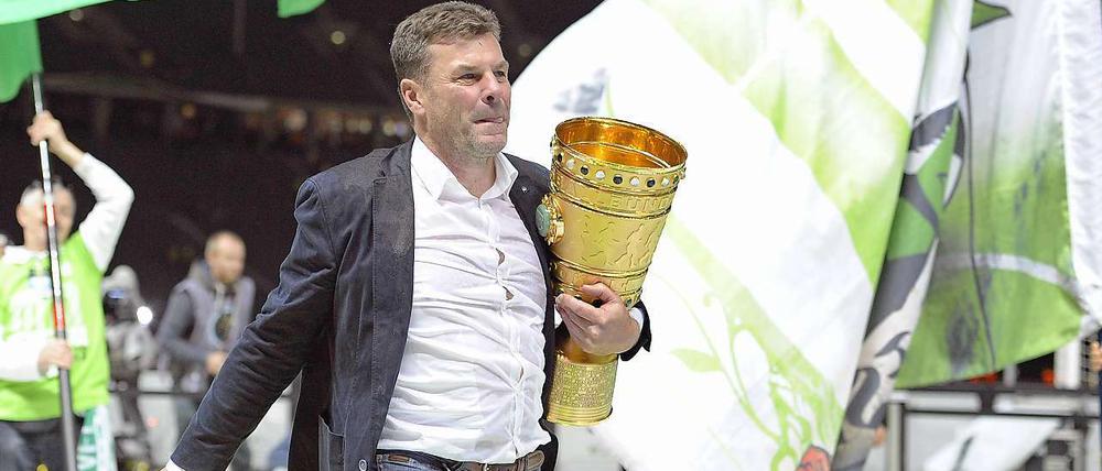 Berlin, Berlin, ich bring' ihn nach Berlin. VfL-Wolfsburg-Trainer Dieter Hecking mit dem DFB-Pokal unterm Arm.