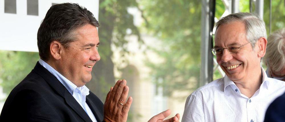 Bundeswirtschaftsminister Sigmar Gabriel (SPD) (l) applaudiert am 13.06.2015 neben dem Chef der Industriegewerkschaft Bergbau, Chemie, Energie (IG BCE), Michael Vassiliadis, auf einer Kundgebung des Deutschen Gewerkschaftsbundes (DGB) im Tarifkonflikt der Sozial- und Erziehungsdienste in Hannover (Niedersachsen).