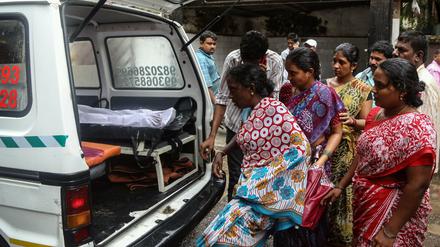 Angehörige der durch gepanschten Schnaps gestorbenen Inder am Freitag auf dem Weg ins Bhagwati Municipal General Hospital in Mumbai.