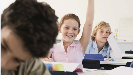 Schulkinder (10-13) sitzen in Klassenzimmer lernen und melden sich. 
