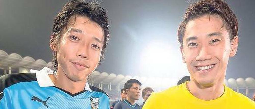 Beliebt. Borussia Dortmund ist derzeit auf Asia-Tour mit Kengo Nakamura (links) und Shinji Kagawa. Die Fußball-Bundesliga wird auch im Ausland gesehen und vermarktet. Bislang machen Ausstrahlungsrechte an Ländergrenzen halt. Kritiker wollen das ändern.