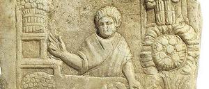 Relief aus der Hafen-Vorstadt Ostia: Ein römischer Straßenhändler verkauft Salat und Gemüse.