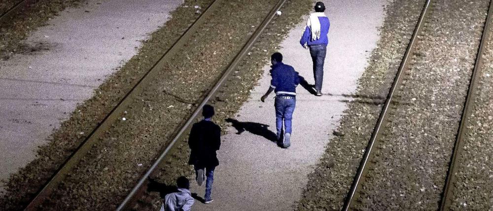 Migranten, die es in Calais über die Absperrungen des Kanaltunnels geschafft haben.