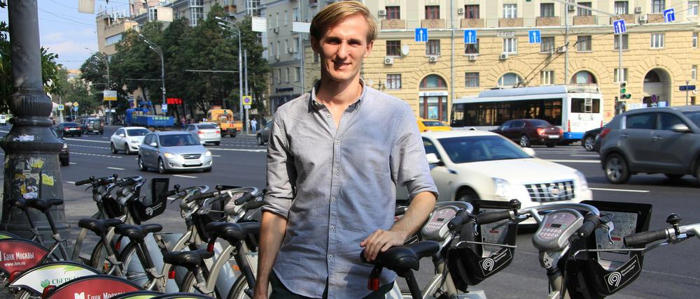 Wladimir Kumow, einer der Organisatoren der Fahrrad-Paraden in Moskau, posiert am 10.08.2015 vor einer Station für öffentliche Leihfahrräder in Moskau.