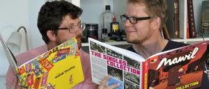 Mawil (links) und Flix beim Vergleichen ihrer druckfrischen Bücher in Flix’ Atelier. Unten zwei Zeichnungen der beiden, mit denen für die Buchvorstellung am Donnerstag geworben wird. Motto: „Fesche Singles und schöne Töchter“.