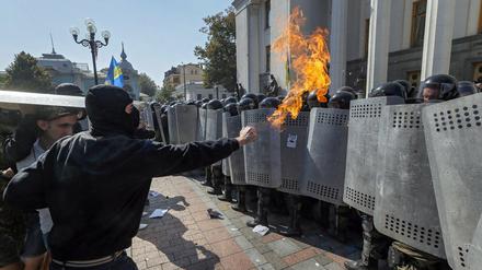 Ukrainische Demonstranten bedrohen die Nationalgarde, die das Parlament zu schützen versucht. 