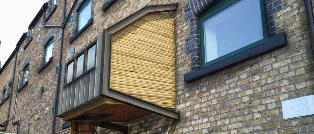 Eine Illustration des Architekten James Furzer zeigt die Holzkästen, die der 26-Jährige für Obdachlose an Hauswänden in London anbringen möchte. 