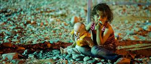 Ein Flüchtlingskind mit einer Puppe in der Nähe der Stadt Gevgelija, Mazedonien.